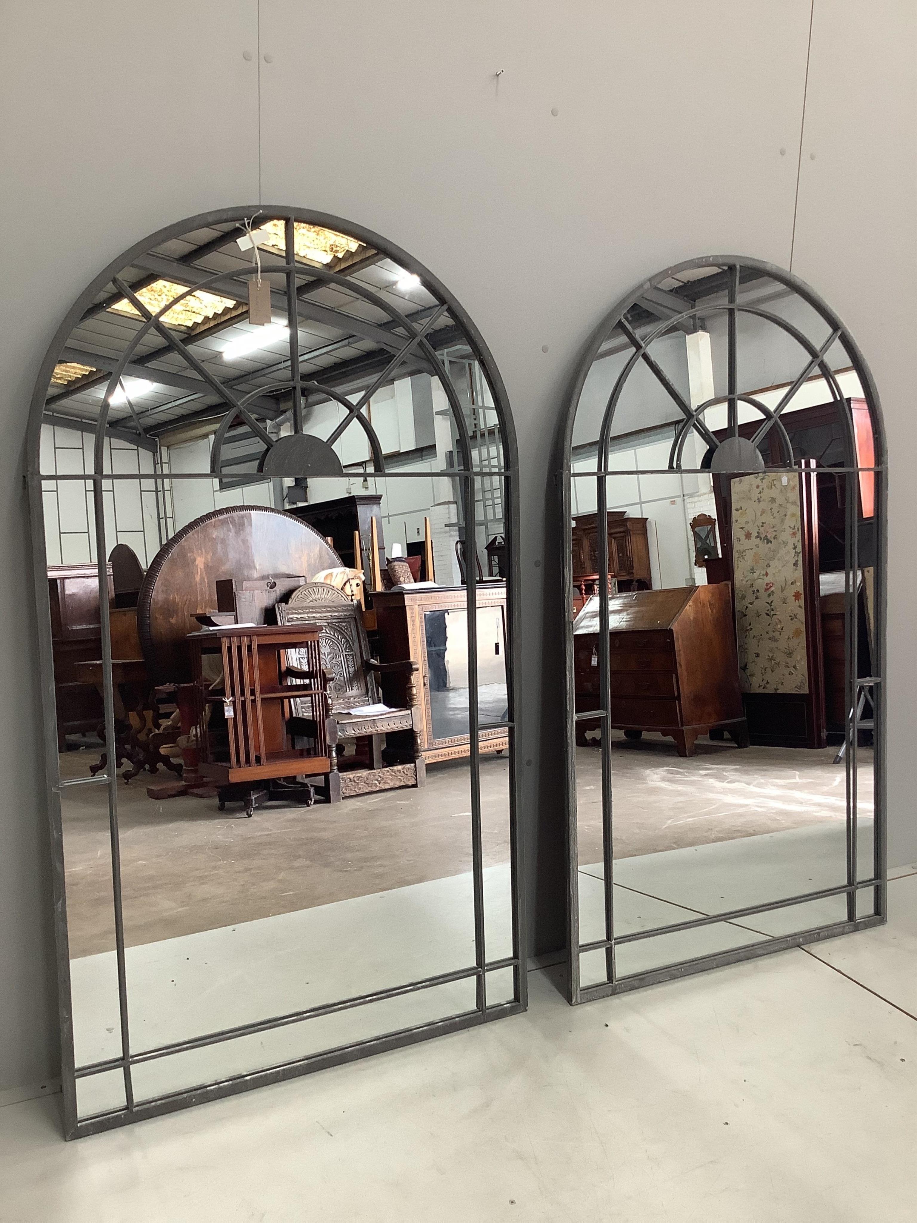 A pair of wrought iron framed window style garden mirrors, each width 90cm, height 156cm. Condition - good